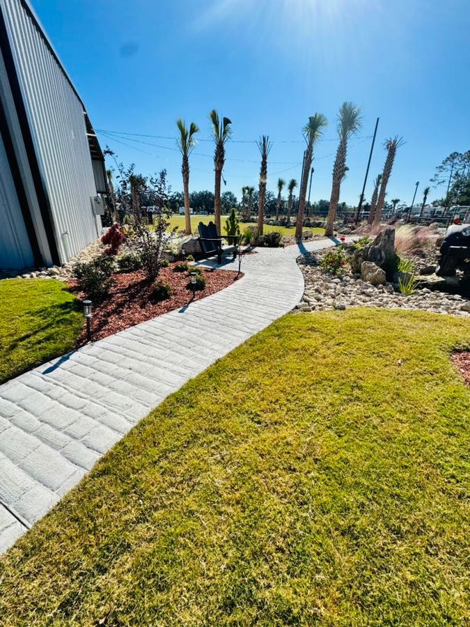Landscaped walkway between the sites and the clubhouse at Heritage Oaks RV Resort