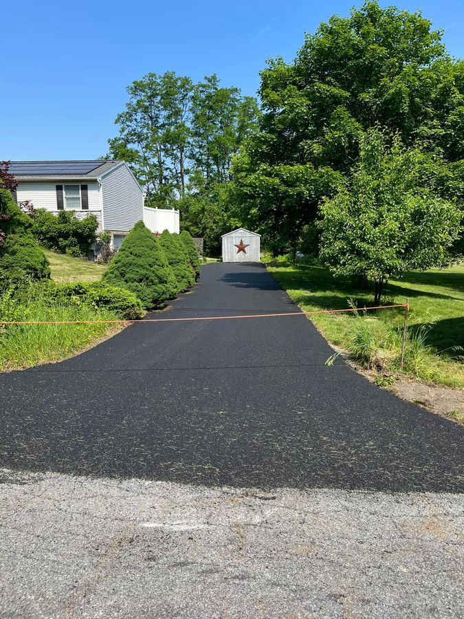 Newly paved driveway with a clean gravel to asphalt transition