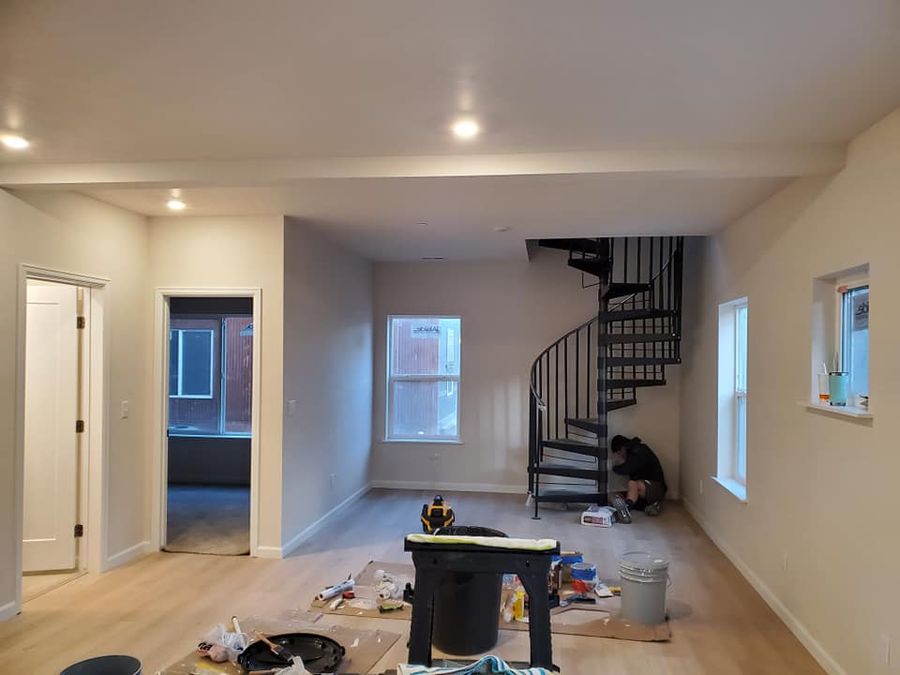 Open room with a spiral stair while painting is in progress