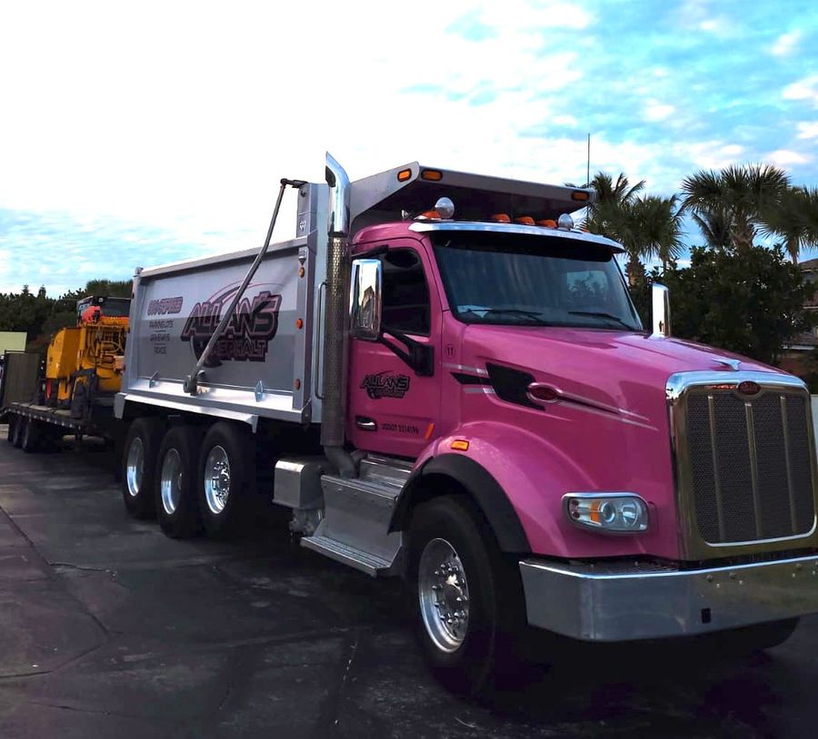 Pink Allan's Asphalt dump truck on a fresh black surface