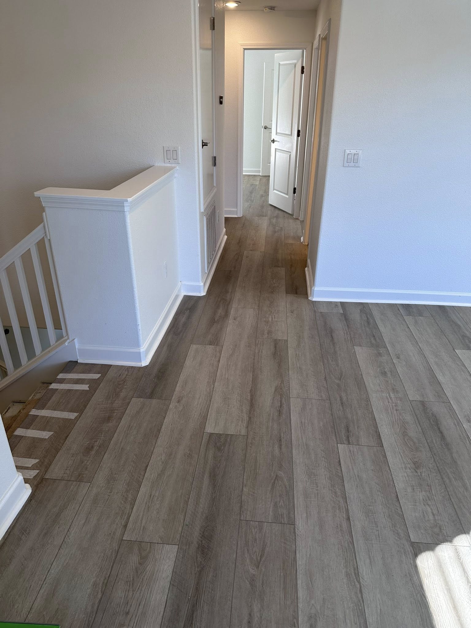 Stair nosing installation in progress on a grey plank landing in Tampa, FL